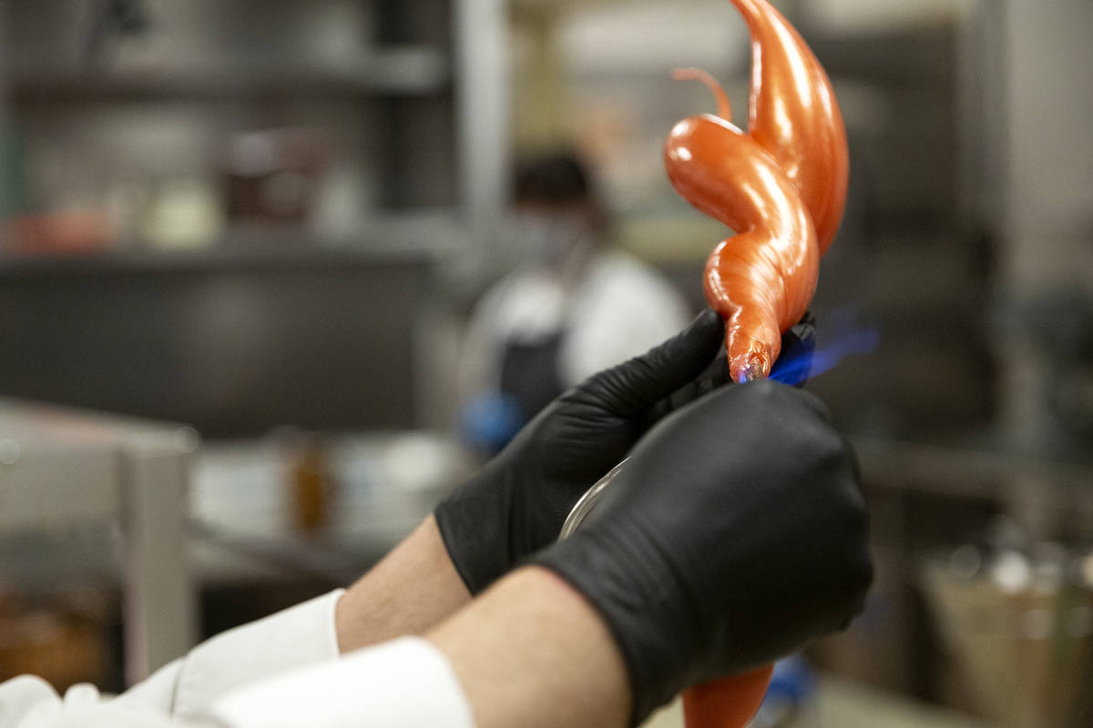 Executive pastry chef Mathieu Lavallee torches a blown sugar flame that will adorn the Raiders ...