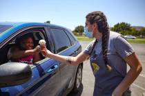 Gabrielle Holloway hands an ice cream to Kerry Nixon outside her family's Baskin Robbins in Hen ...
