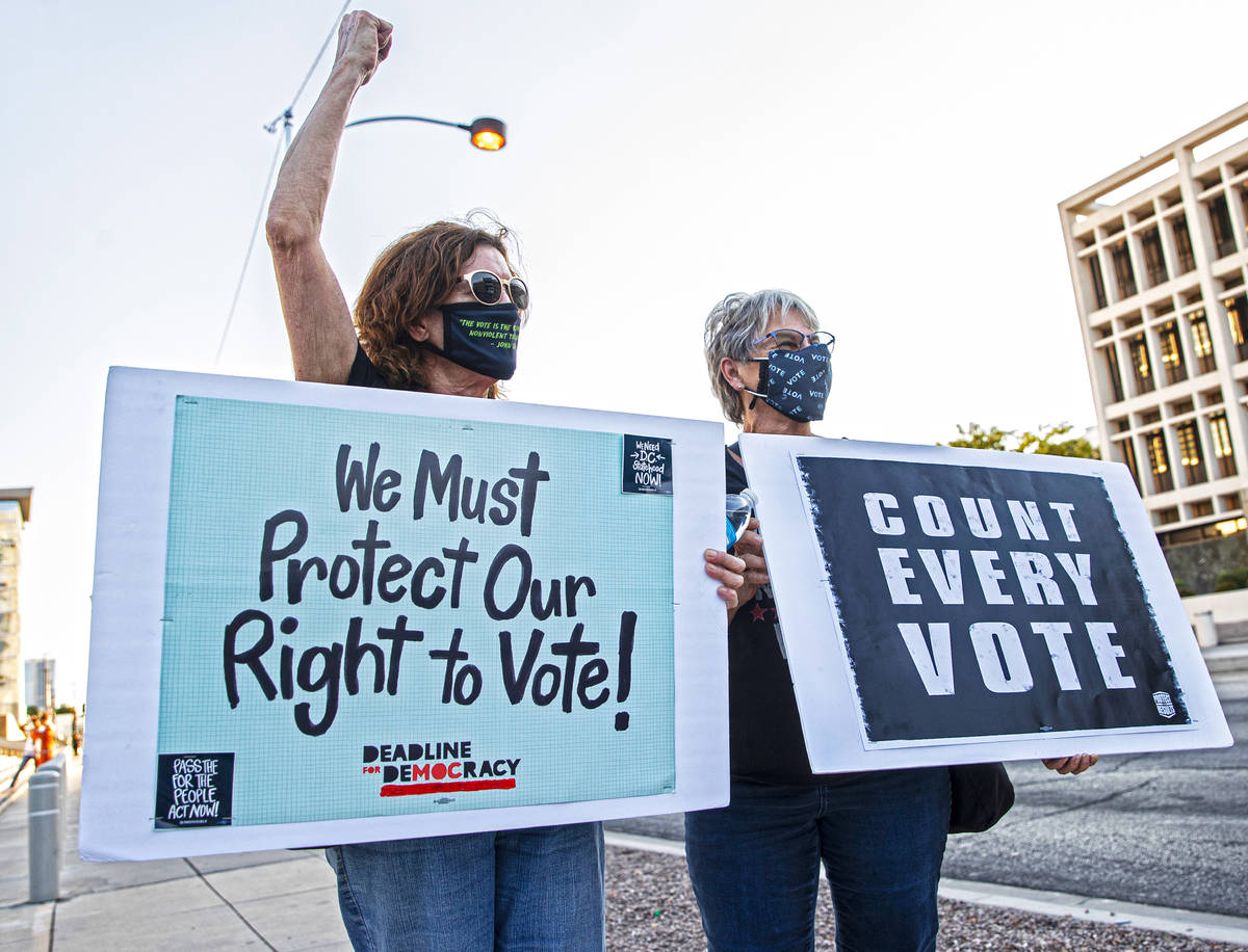 Terri Nordbye, left, and Donna Samatulski demonstrate during an event against voter suppression ...