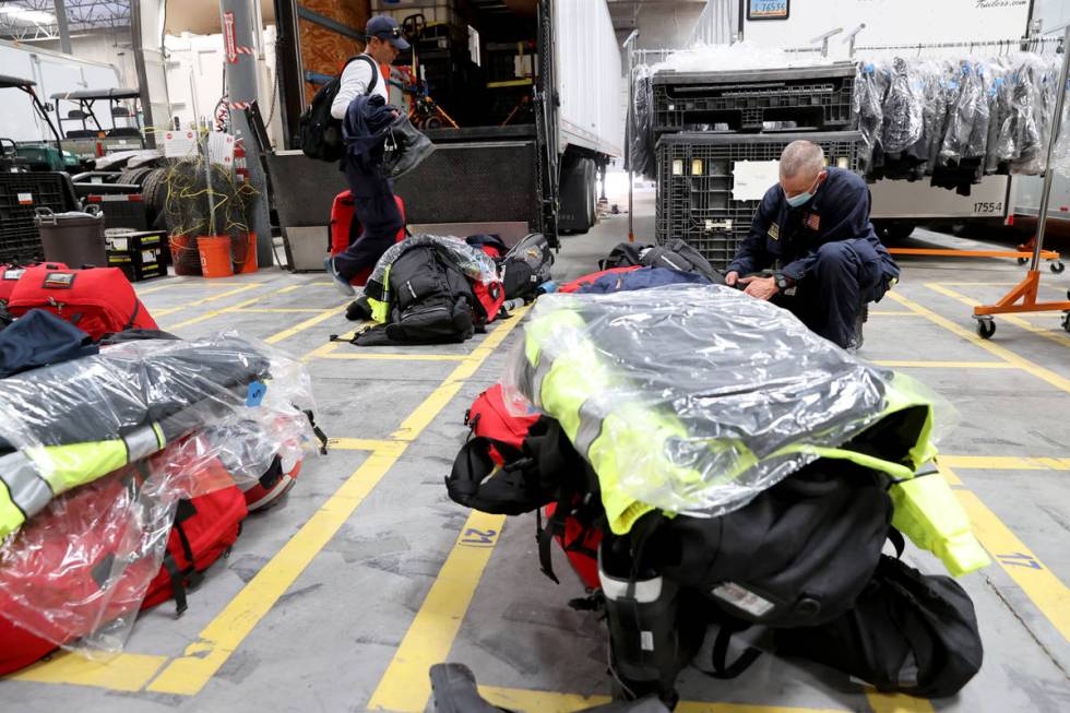 Members of the FEMA Nevada Task Force 1 Urban Search & Rescue team, including Henderson Fir ...