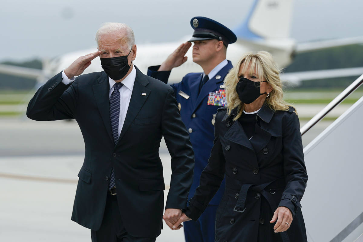 President Joe Biden returns a salute as he and first lady Jill Biden arrive at Dover Air Force ...