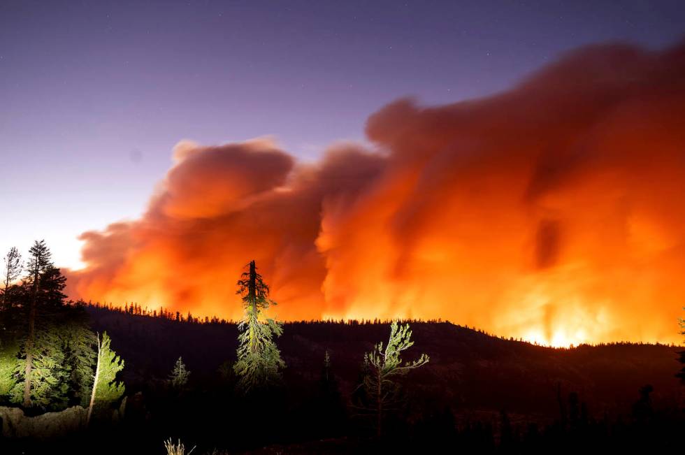 Seen in a long camera exposure, the Caldor Fire burns on Sunday, Aug. 29, 2021, in Eldorado Nat ...