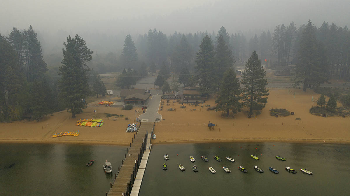 Smoke from the Caldor Fire fills the sky above Lake Tahoe's Zephyr Cove in Douglas County, Nev. ...
