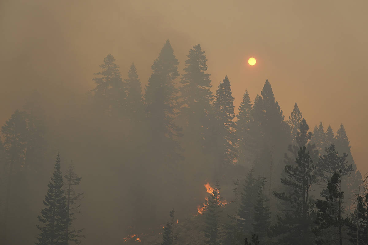 The sun is visible through thick smoke as the Caldor Fire continues to burn in South Lake Tahoe ...