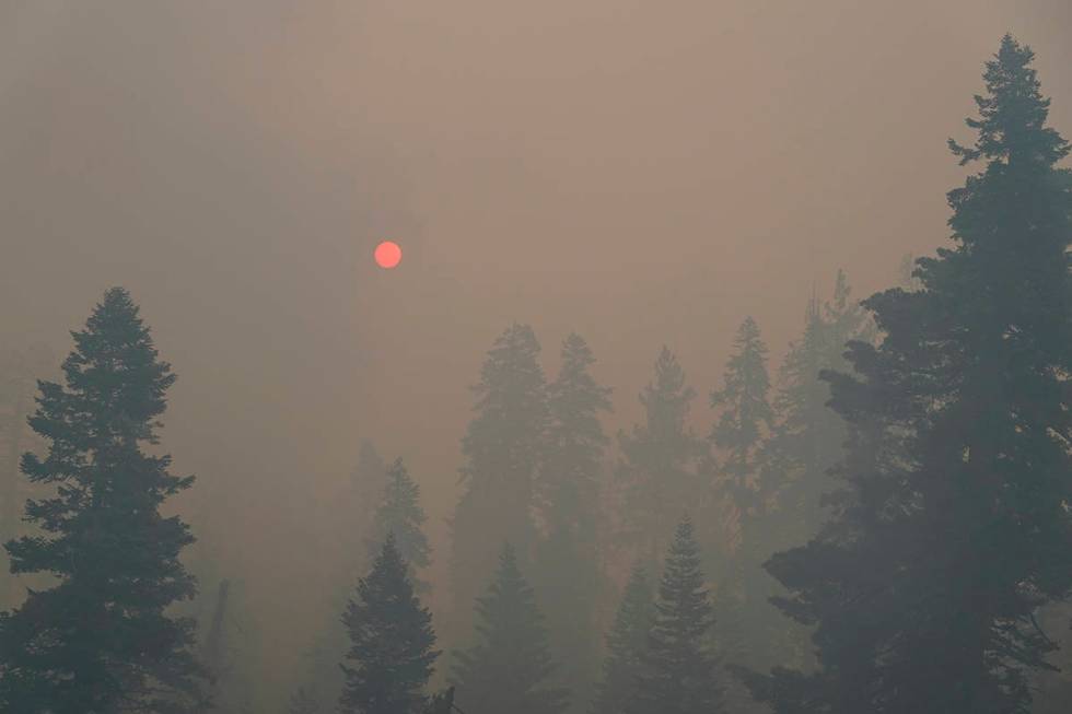 The sun is visible through thick smoke generated by Caldor Fire in South Lake Tahoe, Calif., Tu ...