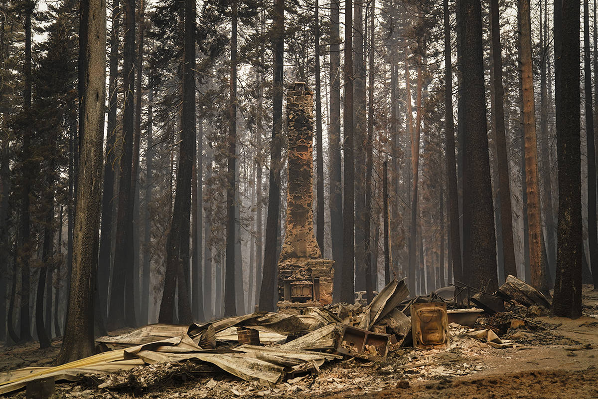 A chimney stands on a property destroyed by the Caldor Fire near South Lake Tahoe, Calif., Tues ...
