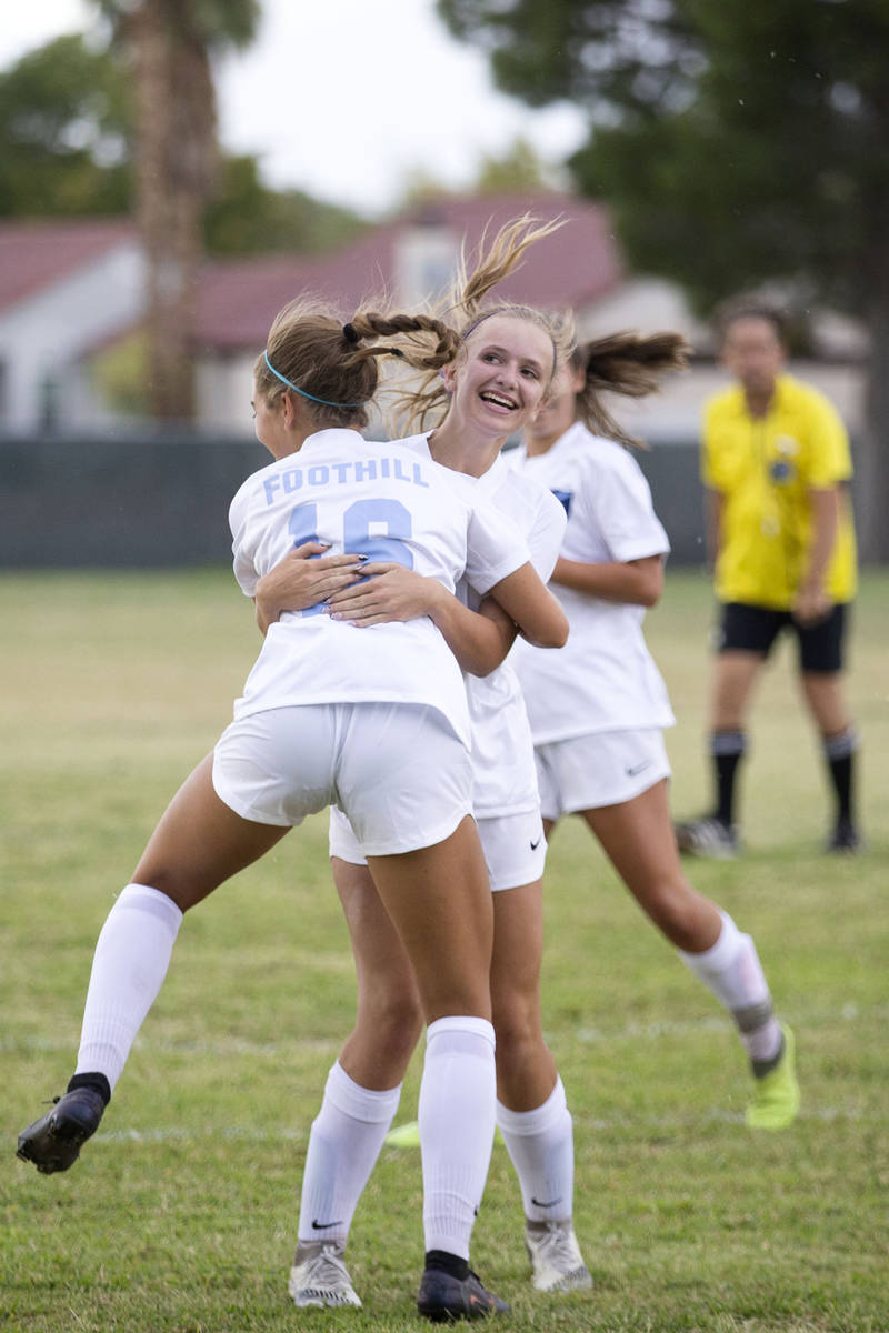 Foothill's Isabelle Simoneau (16) jumps to hug her teammate Emma Rietz (9), who scored a goal o ...
