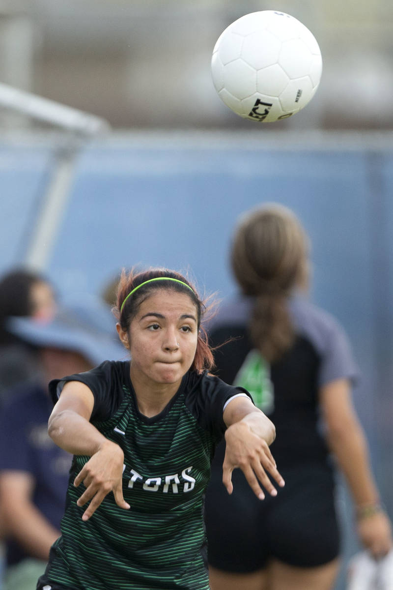 Green Valley's Angelique Ruiz-Salazar (8) throws in during her high school soccer game against ...