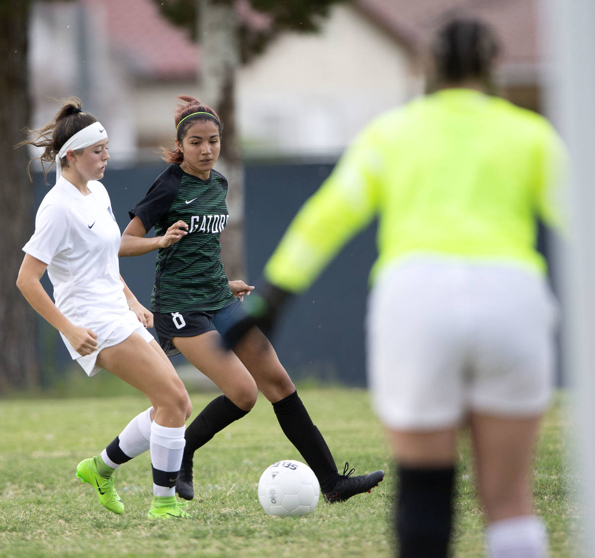 Foothill's Aly Papka (11) catches up with Green Valley's Angelique Ruiz-Salazar (8) while she e ...