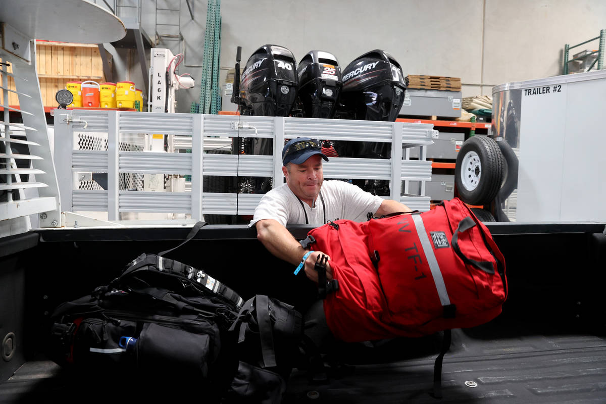 Members of the FEMA Nevada Task Force 1 Urban Search & Rescue team, including Henderson Fir ...