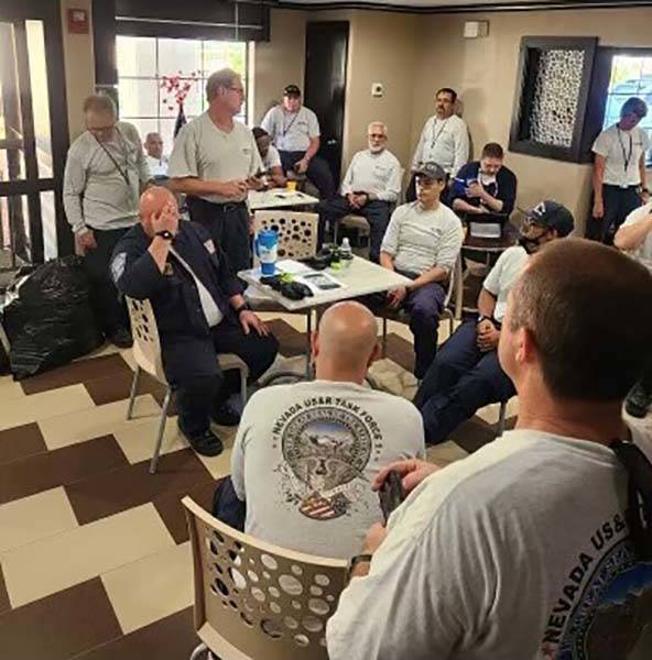 Nevada Task Force 1 Urban Search and Rescue team members receive their mission briefing ...