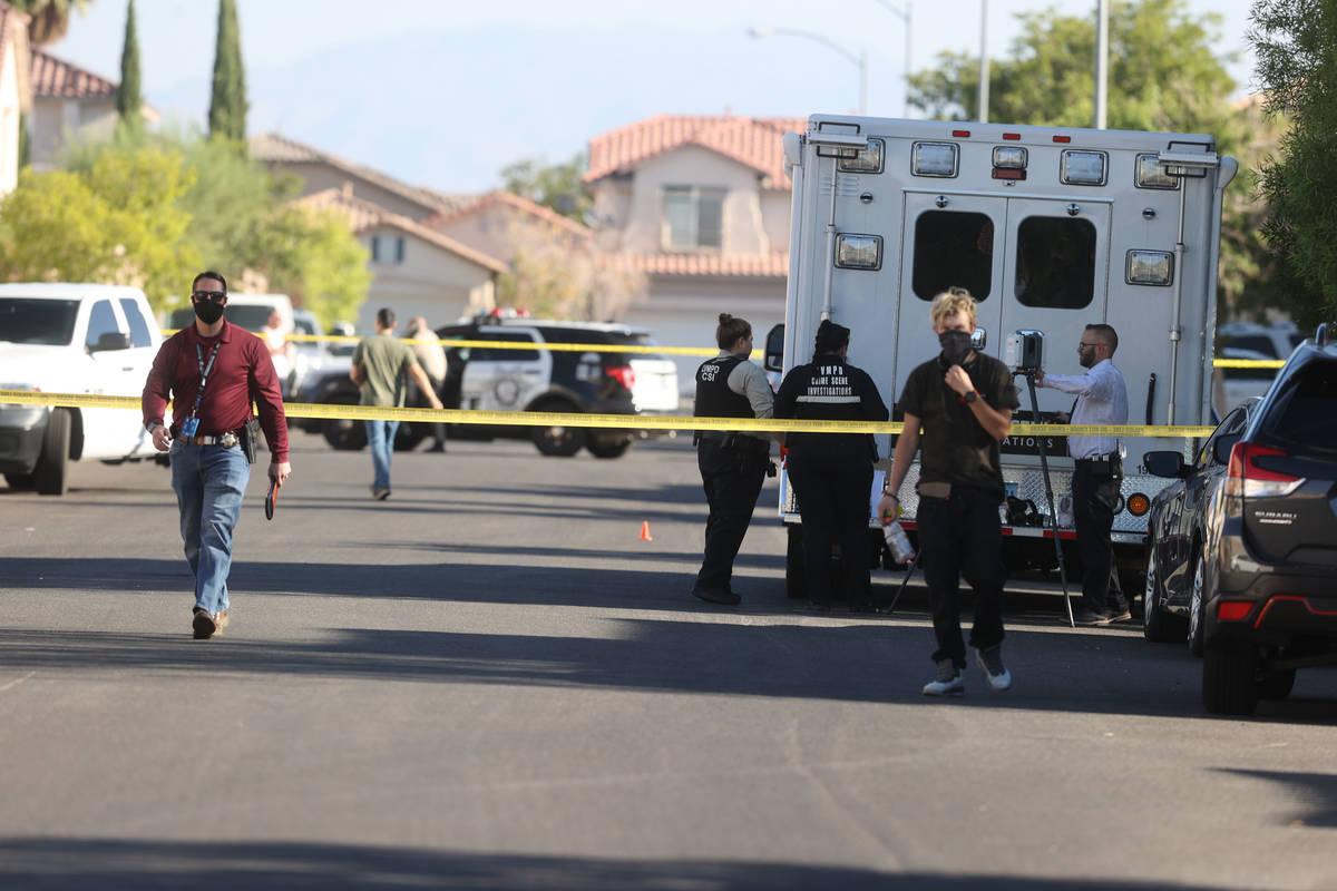 Police investigate a shooting around the 8200 block of Gilded Crown Court, near Desert Inn Road ...