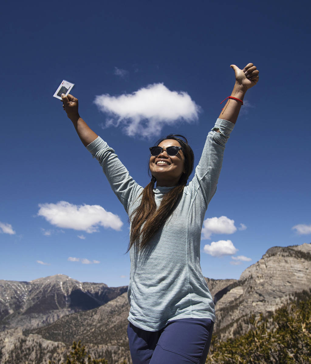Laddawan McQuade celebrates after earning her card at the top of Fletcher Peak at Mount Charles ...