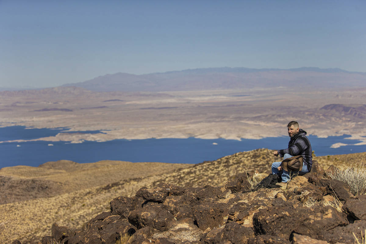52 Peaks hiker Christopher Wagemann looks out at Lake Mead from the peak of Fortification Hill ...