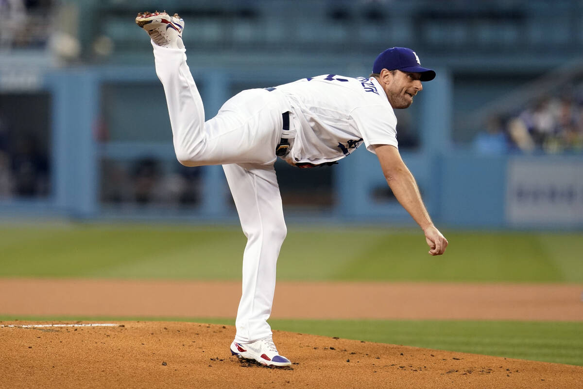 Los Angeles Dodgers starting pitcher Max Scherzer follows through on a throw to an Atlanta Brav ...