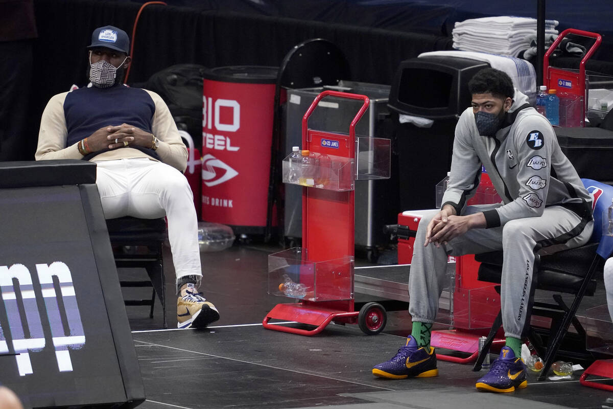 Los Angeles Lakers' LeBron James, left, and Anthony Davis watch play during the second half of ...