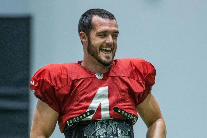 Raiders quarterback Derek Carr (4) laughs with teammates during practice at the Intermountain H ...