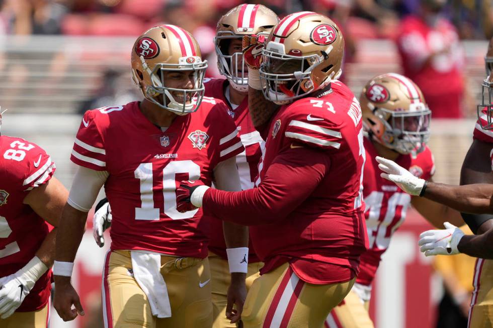 San Francisco 49ers quarterback Jimmy Garoppolo (10) celebrates with offensive tackle Trent Wil ...
