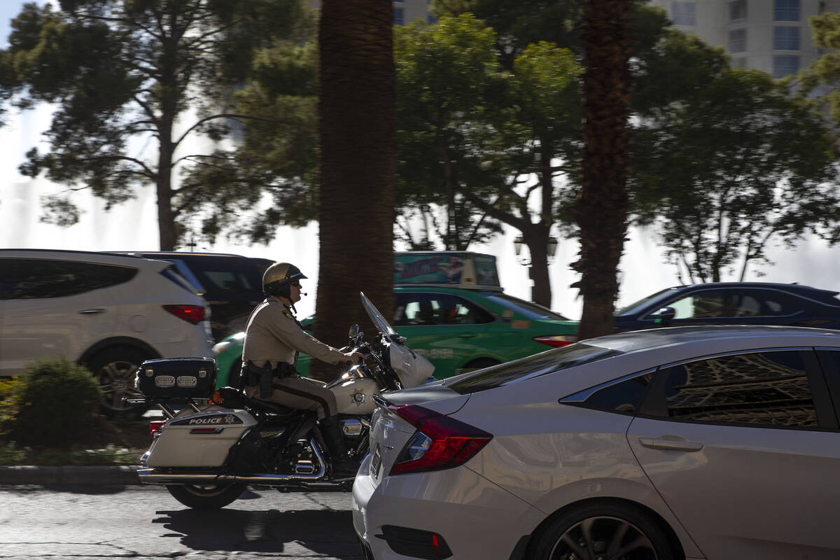A Metropolitan police officer patrols Las Vegas Boulevard during Labor Day weekend on Saturday, ...