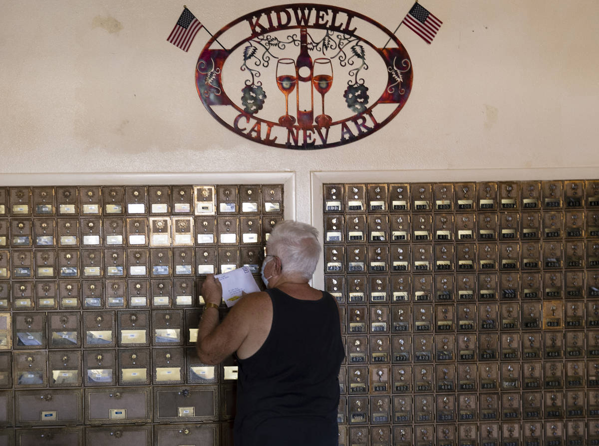 John Davis gets his mail from a communal mailbox inside Cal-Nev-Ari restaurant-casino, on Thurs ...