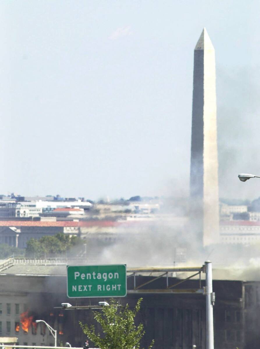 With the Washington Monument in the background, smoke billows from the Pentagon Tuesday, Sept. ...