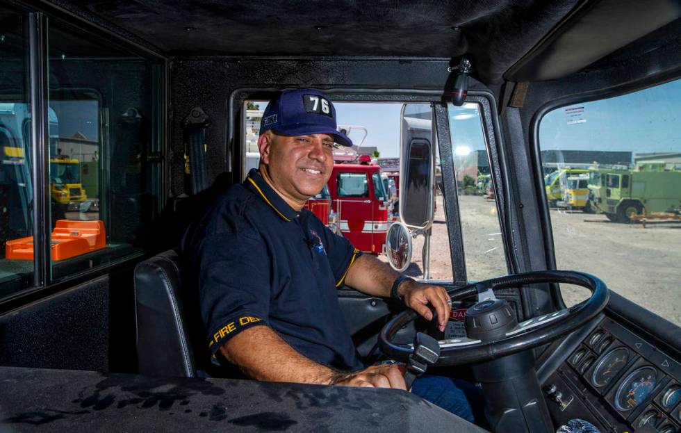 Retired New York firefighter Frank Pizarro poses for a photo inside the cab of his 1991 Pierce ...