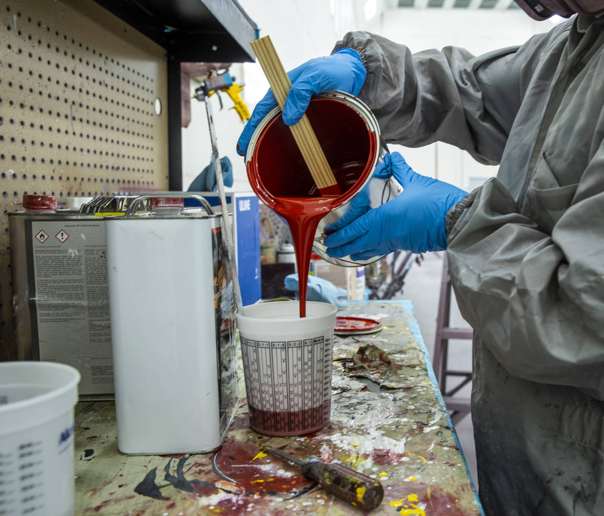 Jomar Reyes mixes red paint June 25 as part of the makeover that Frank Pizarro's 1991 fire truc ...