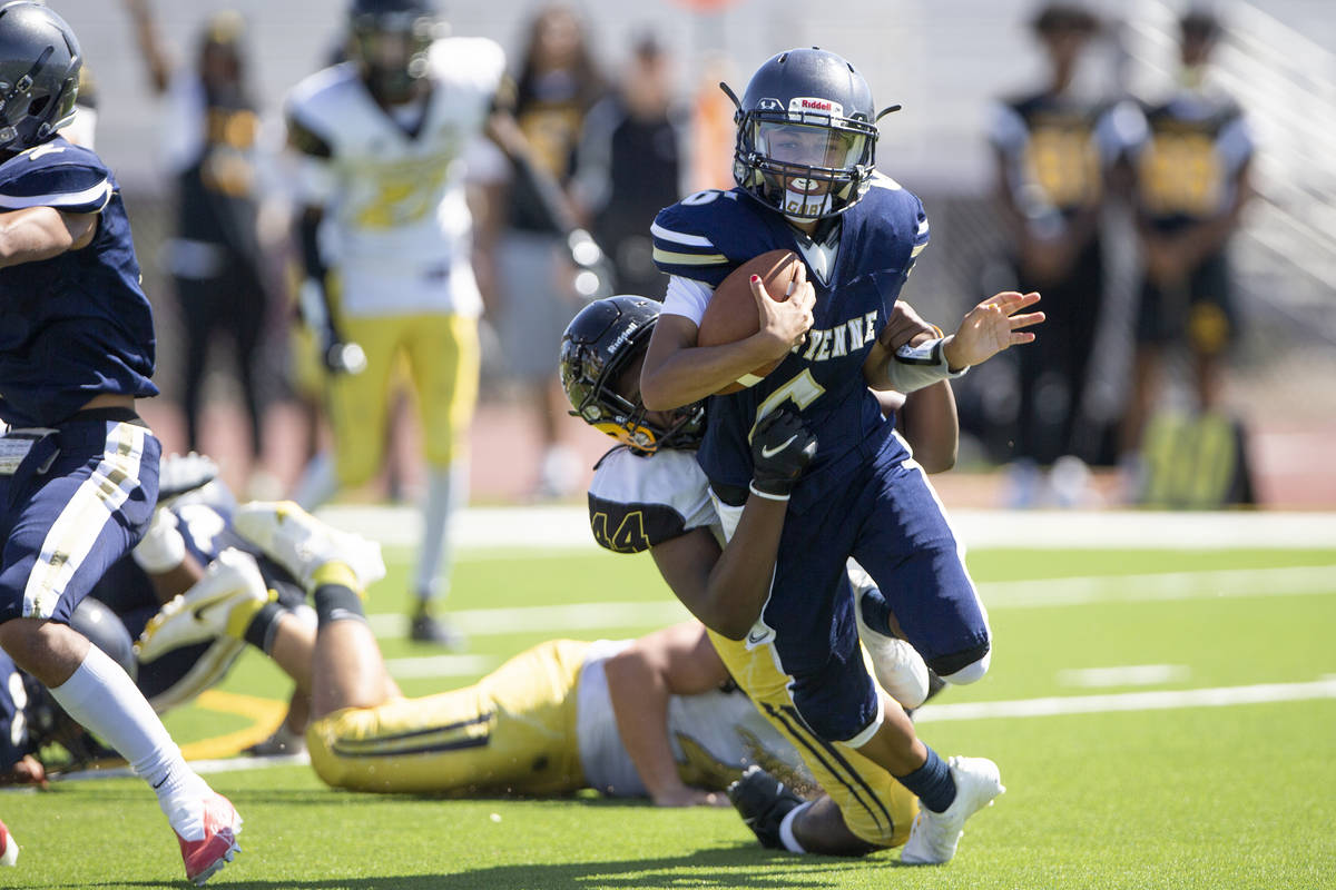 Cheyenne quarterback Kaleigha Plett (6) is tackled by Clark High School's defensive end Jhamari ...