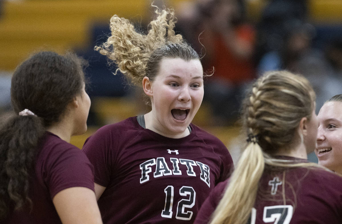 Faith Lutheran’s Delaney Wilson (12) celebrates a big play with teammates during a girls ...