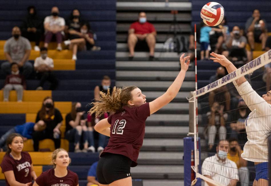 Faith Lutheran’s Delaney Wilson (12) leaps to block a shot during a girls high school vo ...