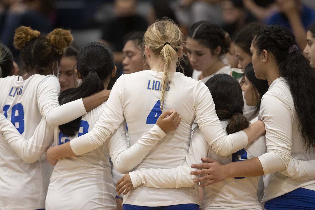 Sierra Vista players lock arms during a timeout during a girls high school volleyball game agai ...