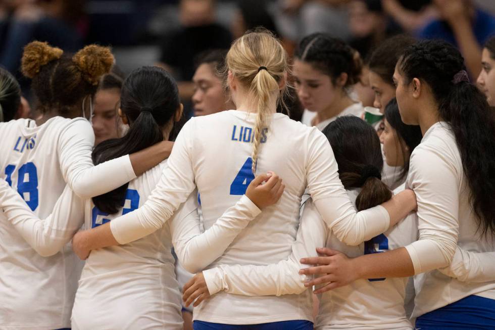 Sierra Vista players lock arms during a timeout during a girls high school volleyball game agai ...