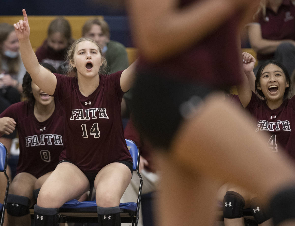 Faith Lutheran’s Ella Rustand (14) and Kayla Tran (4) celebrate a big play with teammate ...