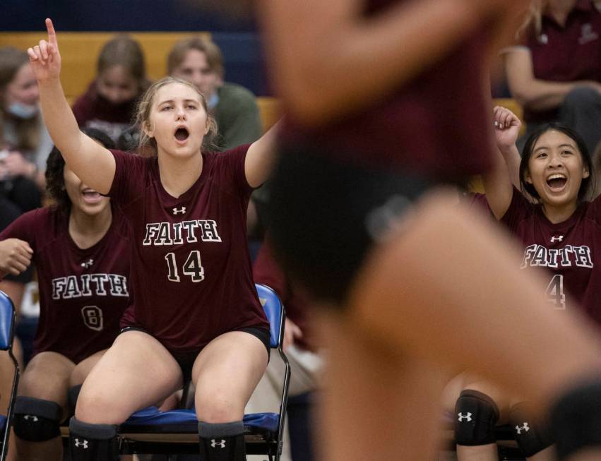 Faith Lutheran’s Ella Rustand (14) and Kayla Tran (4) celebrate a big play with teammate ...