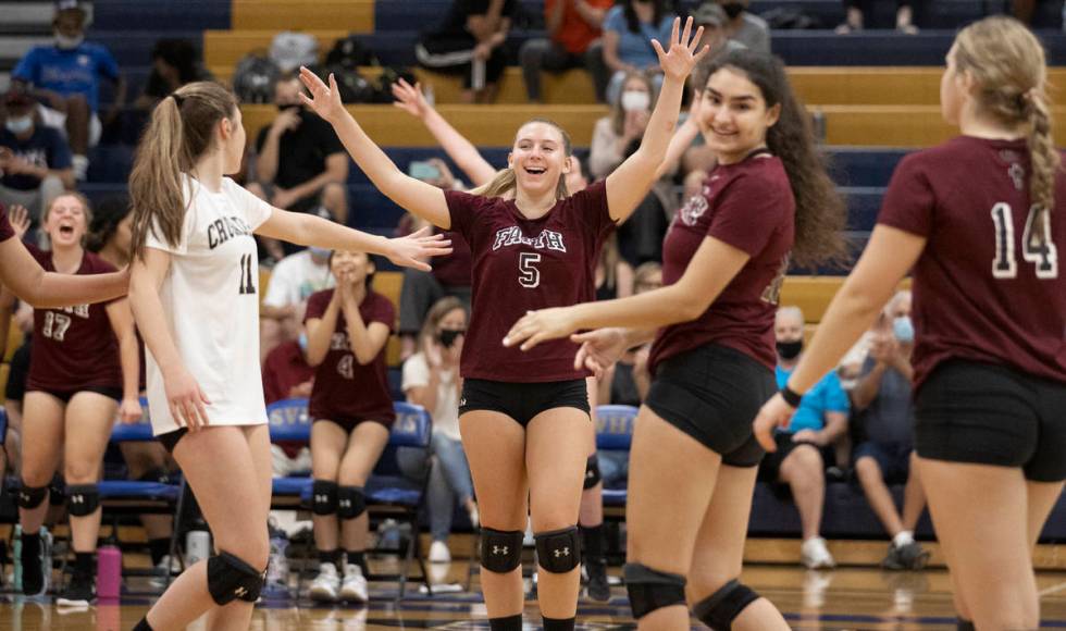 Faith Lutheran’s Kayley Wilcox (5) celebrates a big play with teammates during a girls h ...