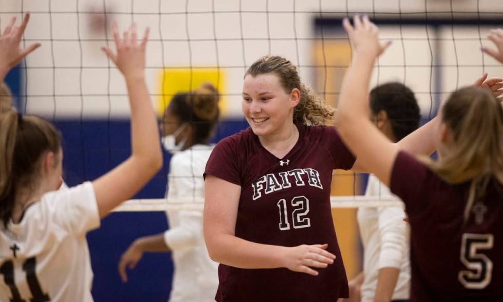 Faith Lutheran’s Delaney Wilson (12) celebrates a big play with teammates during a girls ...