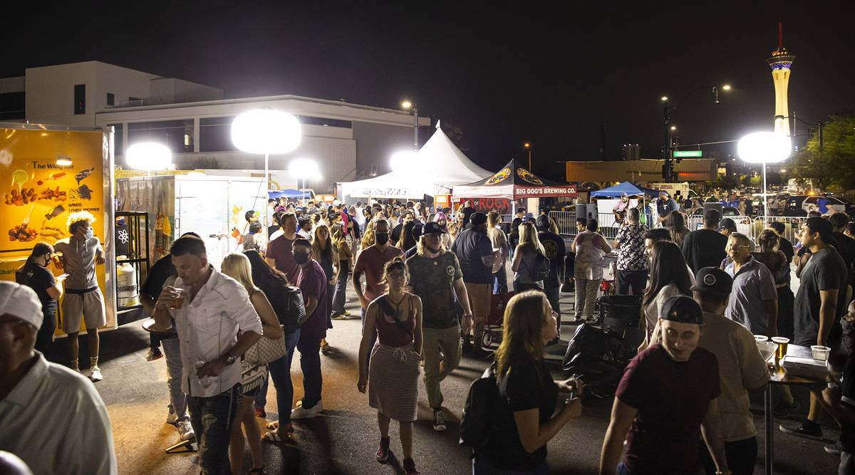 Attendees roam around food vendors during First Friday in the Arts District of downtown Las Veg ...
