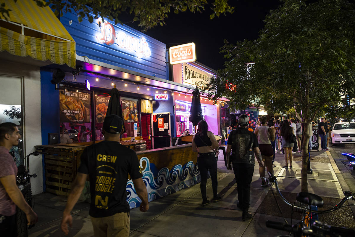 People walk along Main Street during First Friday in the Arts District of downtown Las Vegas on ...