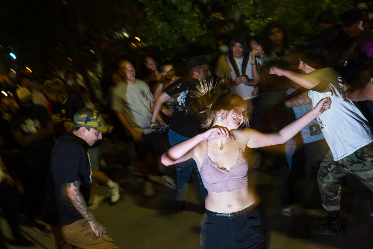 People mosh and dance as Ugly Boy, a band from east Las Vegas, performs during First Friday in ...