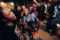 Fans dance during a candlelight vigil on the second anniversary of the death of Tupac Shakur Ab ...
