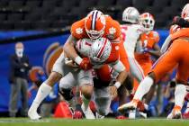 In this Jan. 1, 2021, file photo, Ohio State quarterback Justin Fields is sacked by Clemson def ...