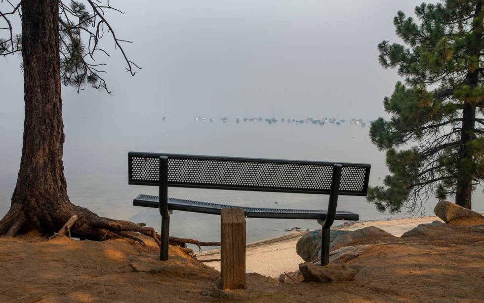 Boats are anchored off the shoreline on a smokey Lake Tahoe as the Caldor Fire continues to bur ...