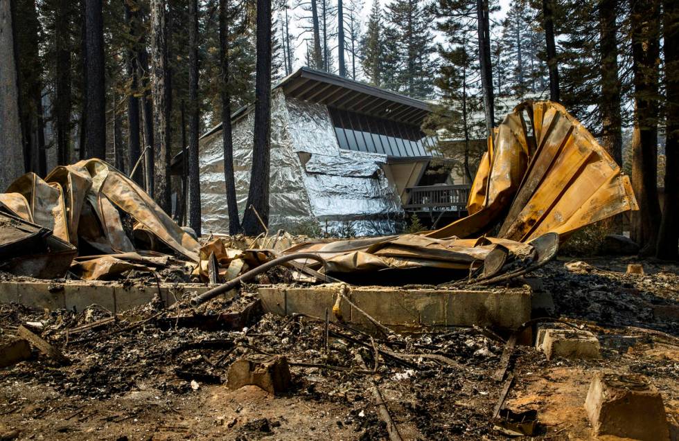 A home in the Phillips Park neighbor wrapped in tin foil is left untouched by the Caldor Fire a ...