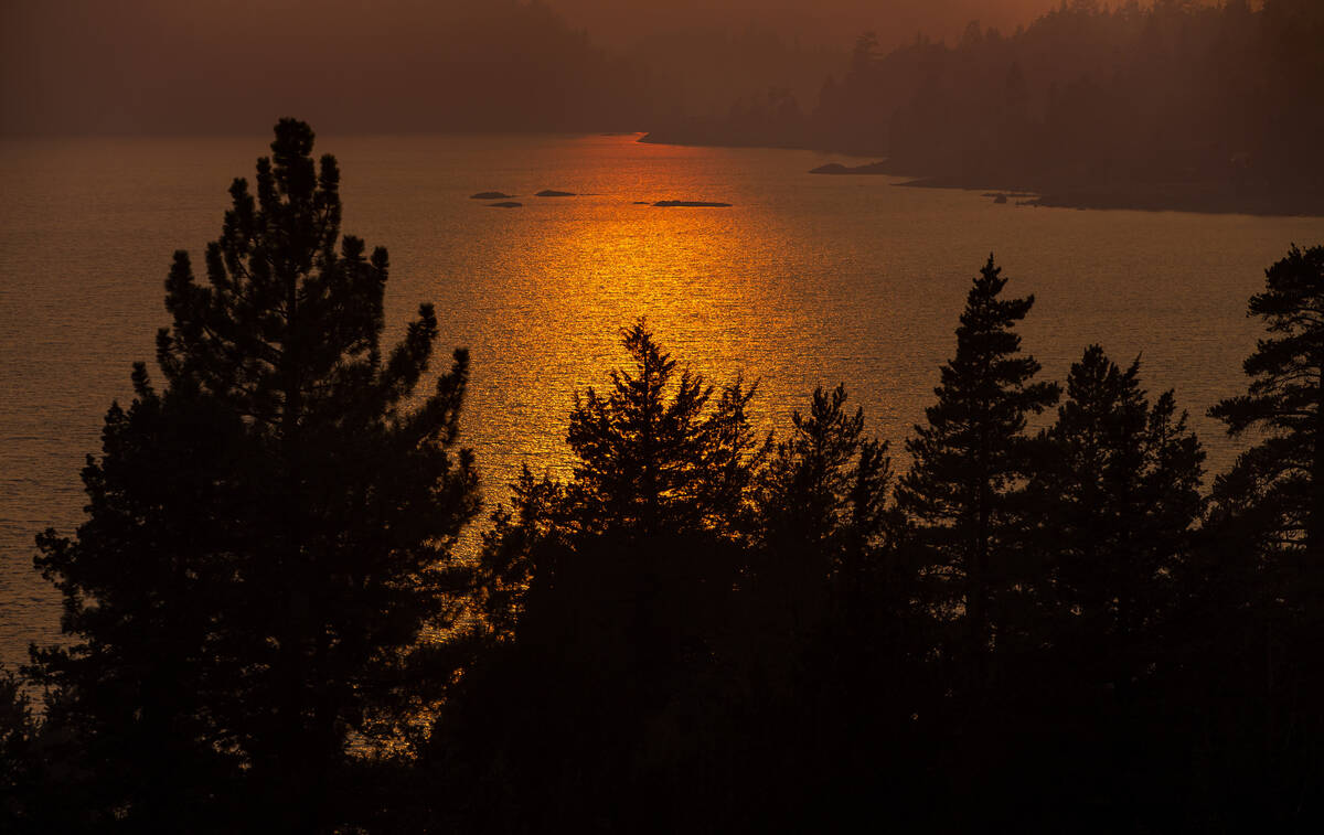 The sun casts a shimmering glow on Red Lake as the Caldor Fire continues to burn on Thursday, S ...