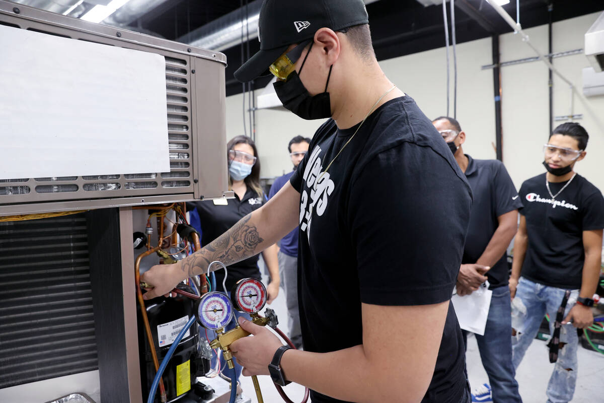 Juan Mendoza works on an air conditioning unit during an HVAC class at College of Southern Neva ...