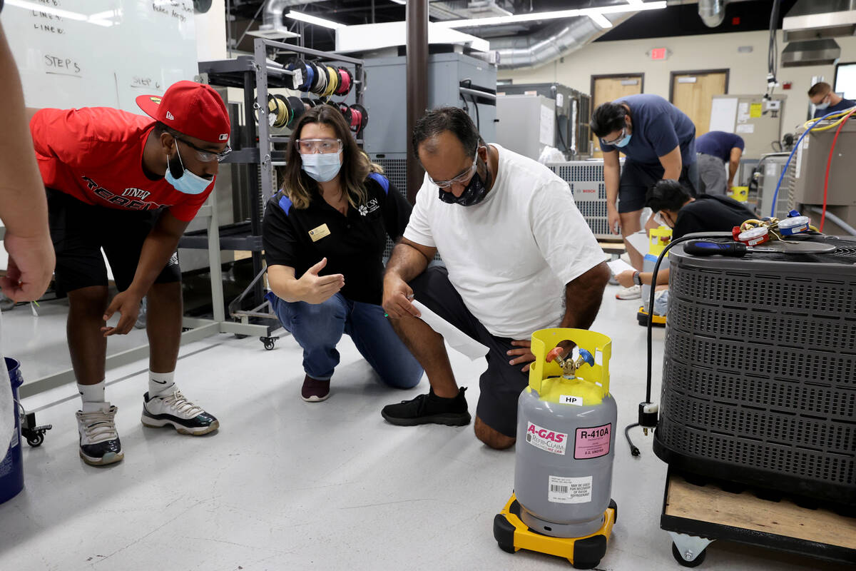 Instructor Crystal Naegle teaches Brandon Dickerson, left, and Eric Ramos during an HVAC class ...