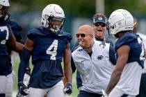 Penn State football coach James Franklin, second from front right, congratulates freshman corne ...