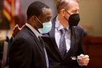 Antonio Bridges, left, who is charged in the death of his girlfriend's 1-year-old son, talks wi ...