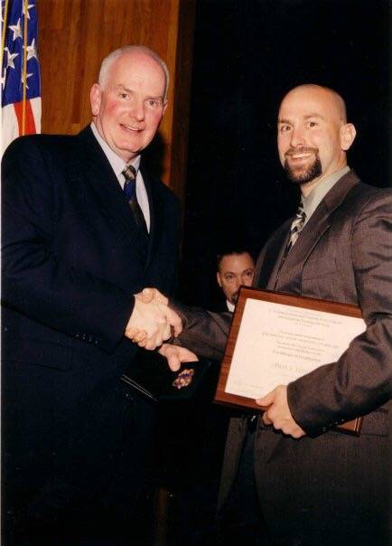 J.T. Stevens, right, at his 2003 graduation from the criminal investigator training program und ...