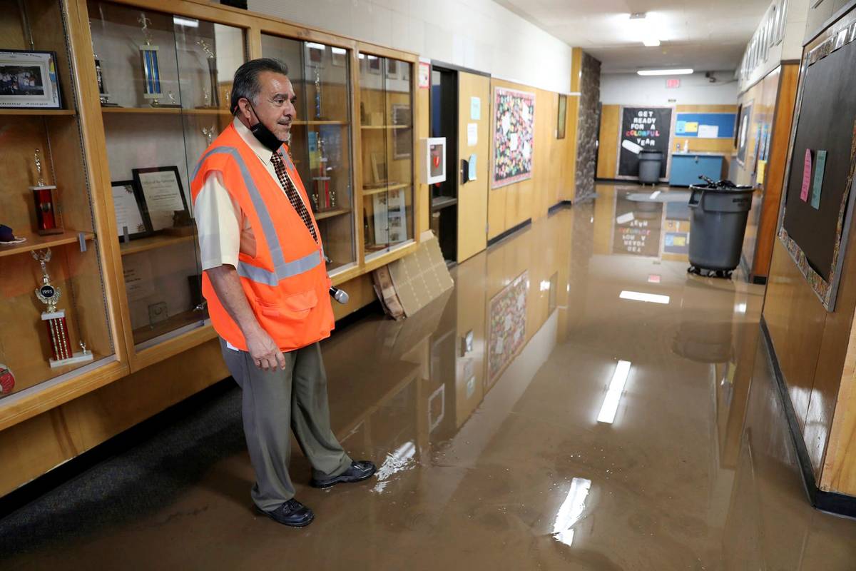 Killip Elementary School principal Joe Gutierrez looks over flooding Tuesday, Aug. 17, 2021, in ...